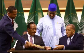 Ethiopian government representative Redwan Hussein (sat left) and Tigray delegate Getachew Reda (sat right) at the official signing of the new Tigray peace agreement in Pretoria, South Africa on 2 November 2022. 